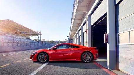 Sleek Red Sports Car at the Track wallpaper
