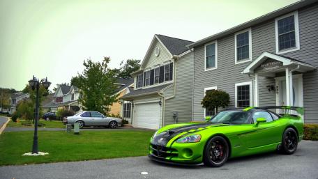 Vibrant Green Sports Car in a Serene Neighborhood Scene wallpaper