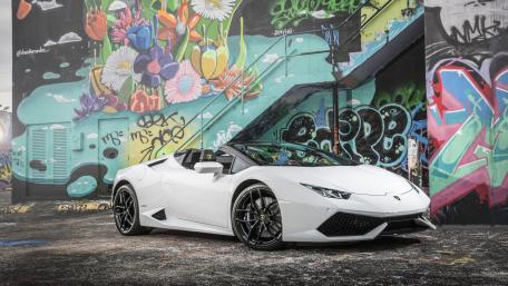 Sleek White Lamborghini Against Colorful Urban Mural wallpaper