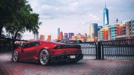 Sleek Luxury Car Against Urban Skyline View wallpaper