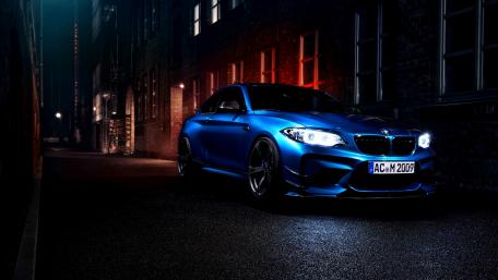 Sleek Blue BMW M2 in Urban Night Setting wallpaper