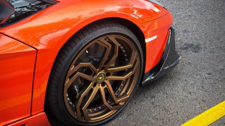 Sleek Orange Car with Stunning Wheels wallpaper