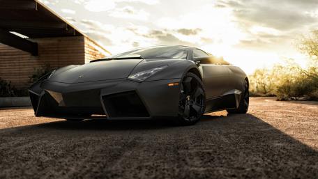 Sleek Black Supercar at Sunset wallpaper