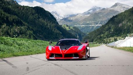 Red Supercar on Scenic Mountain Roadway wallpaper