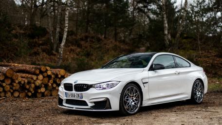 Sleek White BMW M4 in Natural Surroundings wallpaper