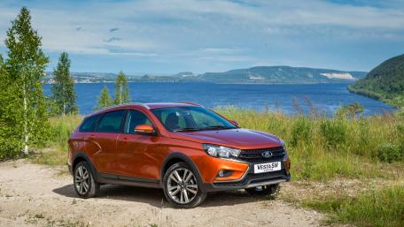 Sleek Orange SUV with Scenic Background wallpaper