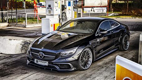 Sleek Black Luxury Car at Fuel Station wallpaper