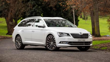 Sleek White Car in Nature Setting wallpaper