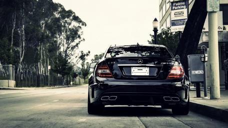 Sleek Black Mercedes C-Class in Urban Setting wallpaper