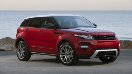 Sleek Red Range Rover by the Water wallpaper