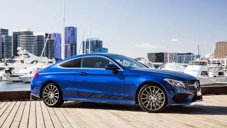 Sleek Blue Luxury Coupe by the Marina wallpaper