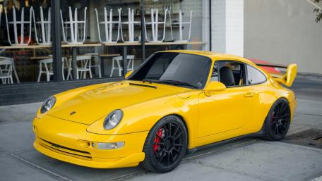 Vibrant Yellow Porsche 911 at the Café Scene wallpaper