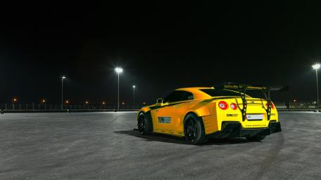 Dynamic Nighttime Race Car Scene with Vibrant Yellow Finish wallpaper