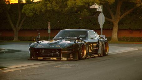 Sleek Black Racing Car on Urban Street wallpaper