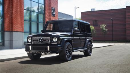 Luxury Black SUV on City Street wallpaper