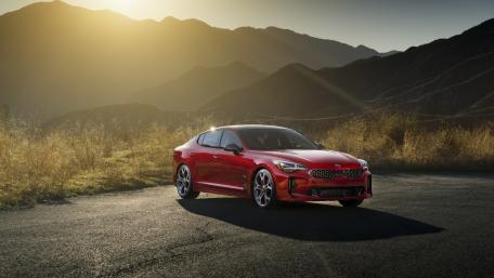 Stunning Red Car Against Majestic Mountains wallpaper