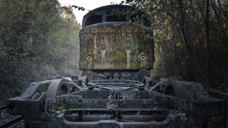 Rusty Train Wreck Amidst Nature's Embrace wallpaper