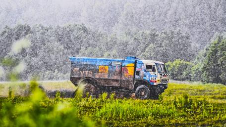 Powerful Rally Truck Racing Through Rainfall wallpaper