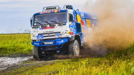 Dynamic Rally Truck in Action on Gravel Road wallpaper