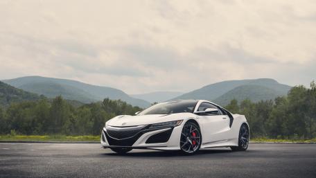 Sleek White Sports Car in Scenic Landscape wallpaper