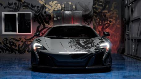 Sleek Black Supercar in Urban Art Space wallpaper