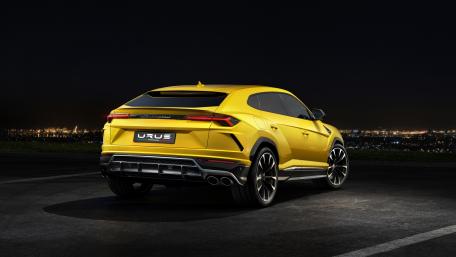 Dynamic Yellow Luxury SUV in Night Cityscape View wallpaper