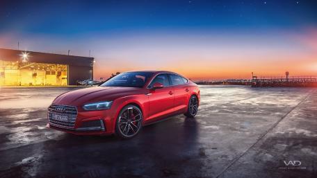 Sleek Red Audi A5 Against a Sunset Sky wallpaper