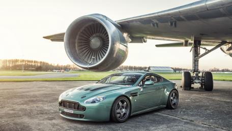 Sleek Car Under Massive Airplane Engine wallpaper