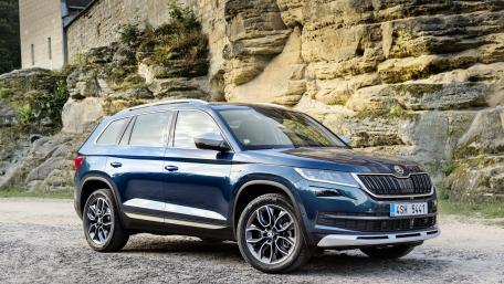 Sleek SUV Against Rocky Terrain wallpaper