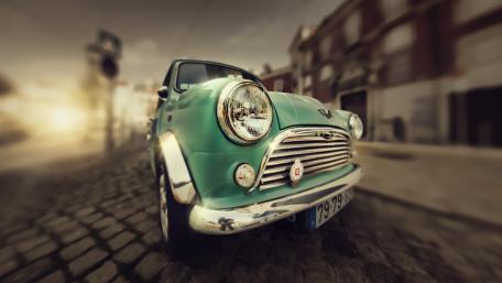 Classic Mini Cooper on Cobblestone Street Wallpaper wallpaper