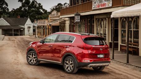 Sleek Red SUV on Historic Street Scene wallpaper