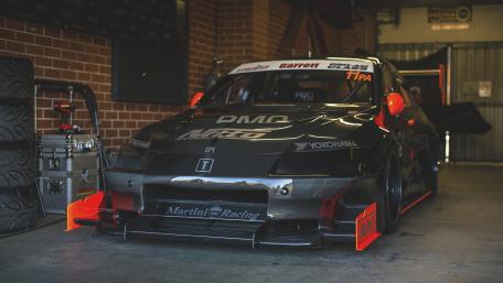 Racing Car Ready for Action in the Garage wallpaper