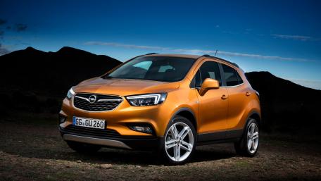 Sleek Orange SUV Against a Dramatic Landscape wallpaper