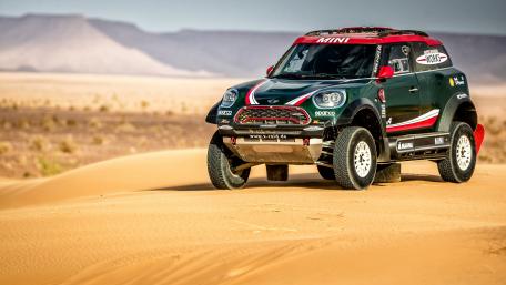 Mini Rally Car in Desert Adventure Scene wallpaper