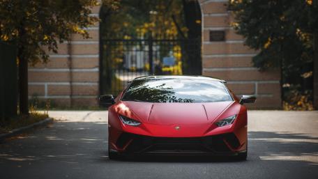 Sleek Red Supercar in Urban Setting wallpaper