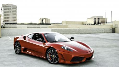 Sleek Red Sports Car on Urban Rooftop wallpaper