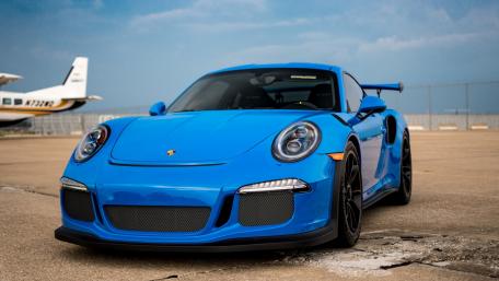 Sleek Blue Porsche on the Tarmac wallpaper