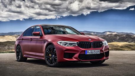 Sleek BMW M5 in Striking Red Wraps wallpaper