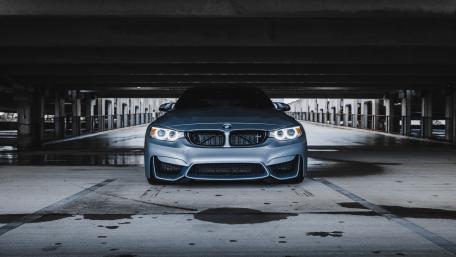 Sleek BMW Under Dimly Lit Structure wallpaper