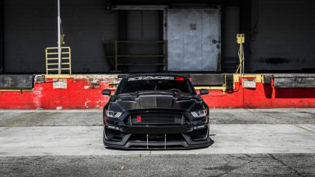 Sleek Black Muscle Car in Urban Setting wallpaper