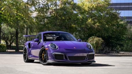 Vibrant Purple Sports Car in Urban Setting wallpaper