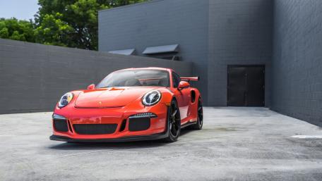 Sleek Red Sports Car in Urban Settings wallpaper