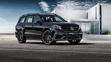 Sleek Black SUV on Asphalt Roadway wallpaper