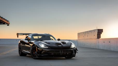 Sleek Black Sports Car at Sunset wallpaper