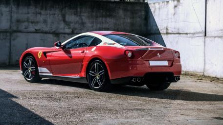 Sleek Red Ferrari in Urban Shadowed Space wallpaper