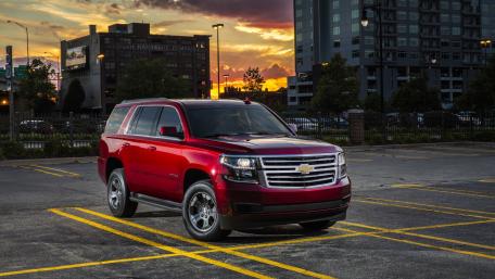 Sleek Red SUV Under Sunset Sky wallpaper