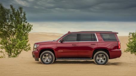 Sleek Red SUV Against Dune Landscape wallpaper