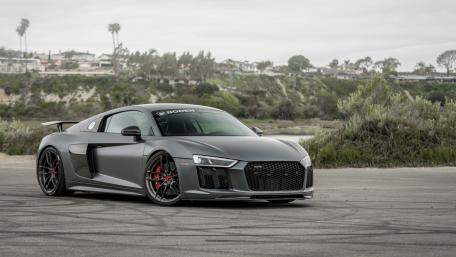 Sleek Modern Supercar on Coastal Roadside wallpaper