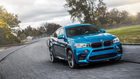Sleek Blue BMW X6 on a Scenic Road wallpaper