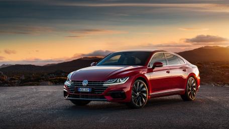 Sleek Red Volkswagen Against a Stunning Sunset wallpaper